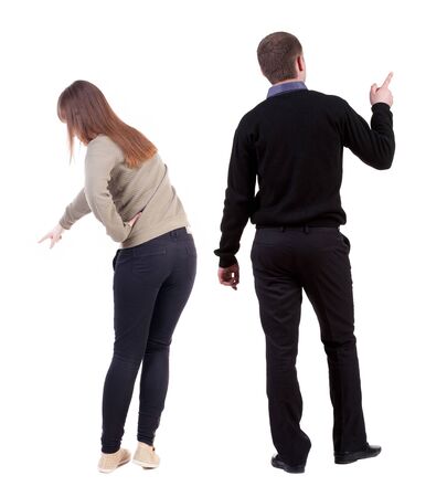 Back view of couple couple in sweater pointing. beautiful friendly girl and guy together. Rear view people collection. backside view of person. Isolated over white background.の写真素材