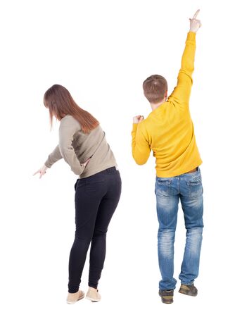 Back view of couple couple in sweater pointing. beautiful friendly girl and guy together. Rear view people collection. backside view of person. Isolated over white background.の写真素材