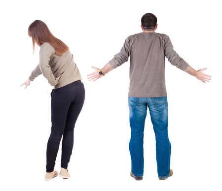 Back view of couple couple in sweater pointing. beautiful friendly girl and guy together. Rear view people collection. backside view of person. Isolated over white background.の写真素材