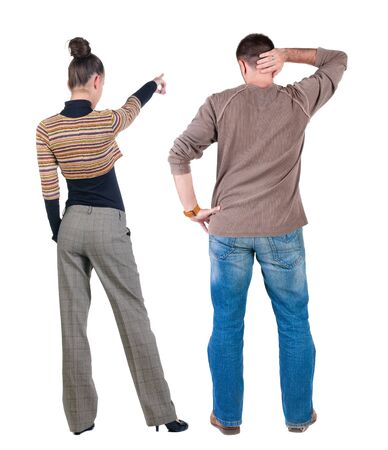 Back view of couple couple in sweater pointing. beautiful friendly girl and guy together. Rear view people collection. backside view of person. Isolated over white background.の写真素材