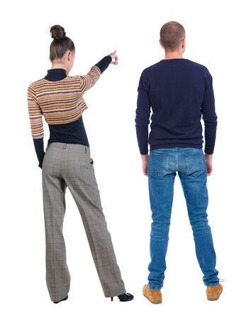 Back view of couple couple in sweater pointing. beautiful friendly girl and guy together. Rear view people collection. backside view of person. Isolated over white background.の写真素材