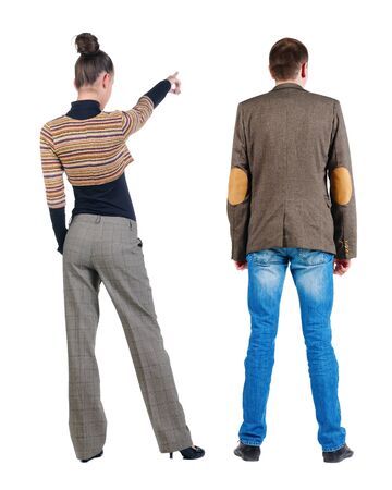 Back view of couple couple in sweater pointing. beautiful friendly girl and guy together. Rear view people collection. backside view of person. Isolated over white background.の写真素材