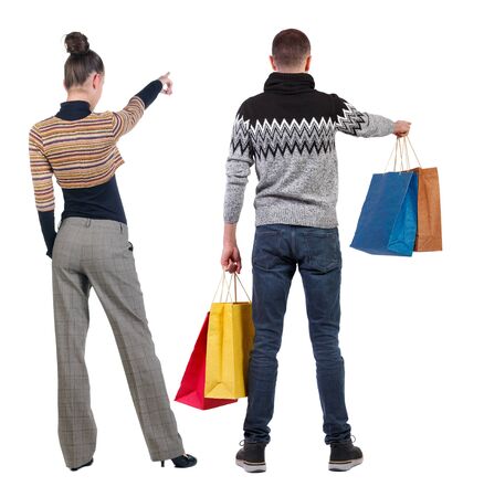 back view of couple with shopping bags. backside view of person. Rear view people collection. Isolated over white background.の写真素材
