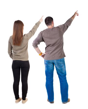Back view of couple couple in sweater pointing. beautiful friendly girl and guy together. Rear view people collection. backside view of person. Isolated over white background.の写真素材