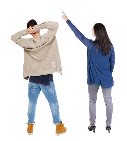 Back view of couple couple in sweater pointing. beautiful friendly girl and guy together. Rear view people collection. backside view of person. Isolated over white background.の写真素材