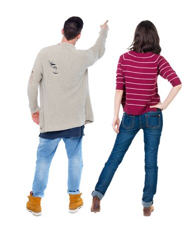 Back view of couple couple in sweater pointing. beautiful friendly girl and guy together. Rear view people collection. backside view of person. Isolated over white background.の写真素材