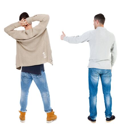 Back view of two man in sweater showing thumb up. Rear view people collection. backside view of person. Isolated over white background.の写真素材
