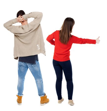 Back view of couple couple in sweater showing thumbs up. beautiful friendly girl and guy together. Rear view people collection. backside view of person. Isolated over white background.の写真素材