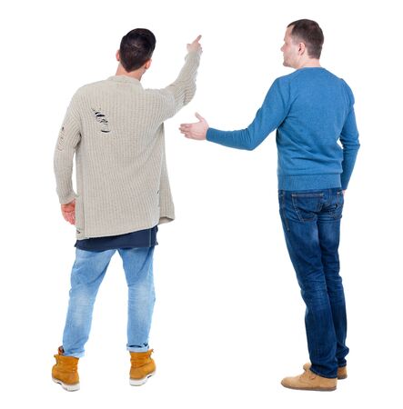 Back view of two man in sweater pointing. Rear view people collection. backside view of person. Isolated over white background.の写真素材