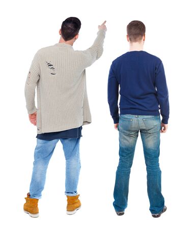 Back view of two man in sweater pointing. Rear view people collection. backside view of person. Isolated over white background.の写真素材