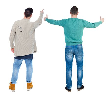 Back view of two man in sweater pointing. Rear view people collection. backside view of person. Isolated over white background.の写真素材