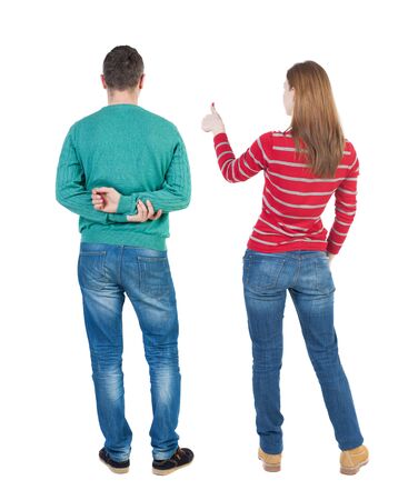 Back view of couple couple in sweater showing thumbs up. beautiful friendly girl and guy together. Rear view people collection. backside view of person. Isolated over white background.の写真素材