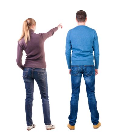 Back view of couple couple in sweater pointing. beautiful friendly girl and guy together. Rear view people collection. backside view of person. Isolated over white background.の写真素材