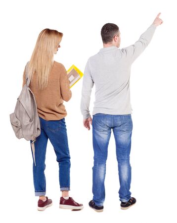 Back view of couple couple in sweater pointing. beautiful friendly girl and guy together. Rear view people collection. backside view of person. Isolated over white background.の写真素材