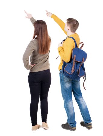 Back view of couple couple in sweater pointing. beautiful friendly girl and guy together. Rear view people collection. backside view of person. Isolated over white background.の写真素材
