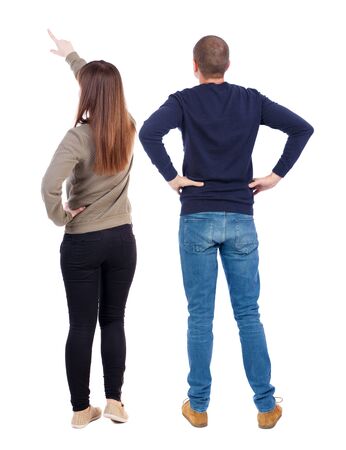 Back view of couple couple in sweater pointing. beautiful friendly girl and guy together. Rear view people collection. backside view of person. Isolated over white background.の写真素材