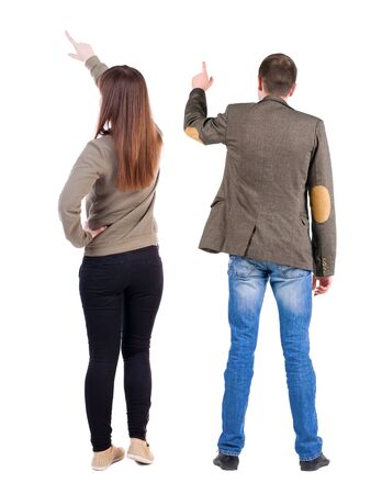 Back view of couple couple in sweater pointing. beautiful friendly girl and guy together. Rear view people collection. backside view of person. Isolated over white background.の写真素材