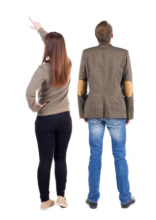 Back view of couple couple in sweater pointing. beautiful friendly girl and guy together. Rear view people collection. backside view of person. Isolated over white background.の写真素材