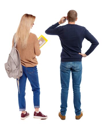 Back view of couple in sweater with mobile phone. beautiful friendly girl and guy together. Rear view people collection. backside view of person. Isolated over white background.の写真素材
