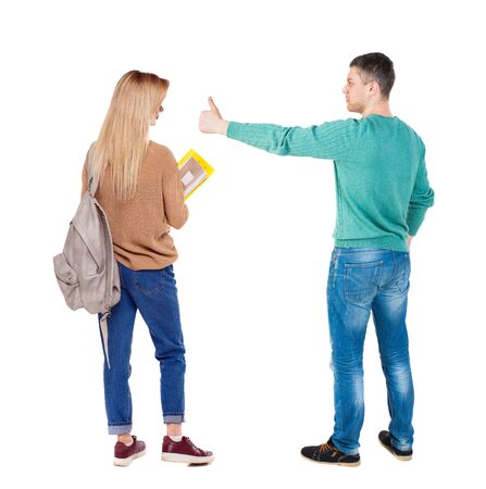 Back view of couple couple in sweater showing thumbs up. beautiful friendly girl and guy together. Rear view people collection. backside view of person. Isolated over white background.の写真素材
