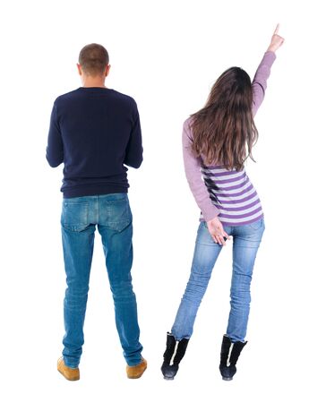 Back view of couple couple in sweater pointing. beautiful friendly girl and guy together. Rear view people collection. backside view of person. Isolated over white background.の写真素材