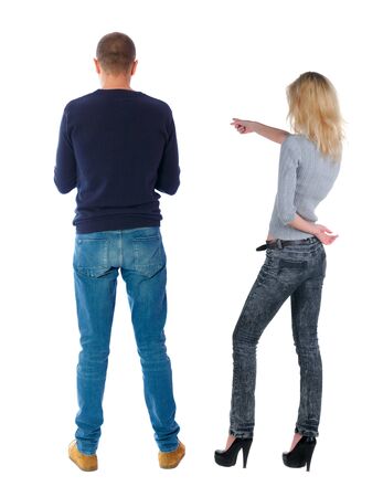Back view of couple couple in sweater pointing. beautiful friendly girl and guy together. Rear view people collection. backside view of person. Isolated over white background.の写真素材