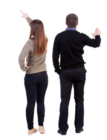 Back view of couple couple in sweater pointing. beautiful friendly girl and guy together. Rear view people collection. backside view of person. Isolated over white background.の写真素材