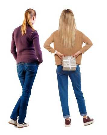 Back view of two woman in sweater. beautiful friendly girl and guy together. Rear view people collection. backside view of person. Isolated over white background.の写真素材