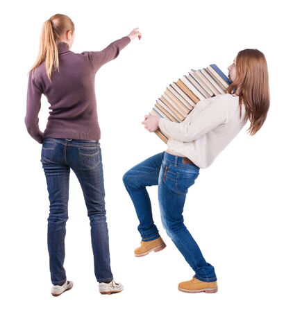Back view of two pointing young girl in sweater. Rear view people collection. backside view of person. beautiful woman friends showing gesture. Rear view. Isolated over white background.の写真素材
