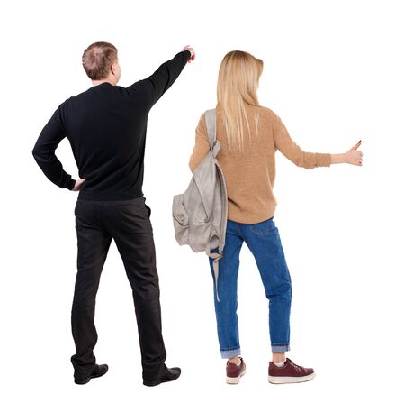 Back view of couple couple in sweater pointing. beautiful friendly girl and guy together. Rear view people collection. backside view of person. Isolated over white background.の写真素材