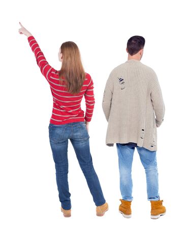 Back view of couple couple in sweater pointing. beautiful friendly girl and guy together. Rear view people collection. backside view of person. Isolated over white background.の写真素材