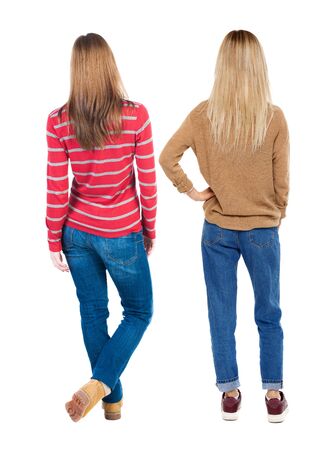 Back view of two woman in sweater. beautiful friendly girl and guy together. Rear view people collection. backside view of person. Isolated over white background.の写真素材