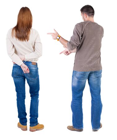 Back view of couple couple in sweater pointing. beautiful friendly girl and guy together. Rear view people collection. backside view of person. Isolated over white background.の写真素材