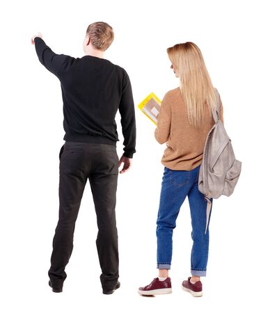 Back view of couple couple in sweater pointing. beautiful friendly girl and guy together. Rear view people collection. backside view of person. Isolated over white background.の写真素材