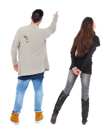 Back view of couple couple in sweater pointing. beautiful friendly girl and guy together. Rear view people collection. backside view of person. Isolated over white background.の写真素材