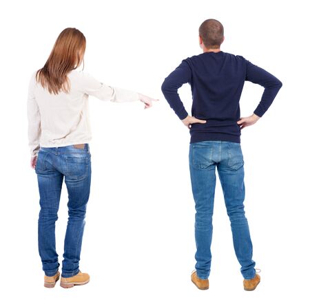 Back view of couple couple in sweater pointing. beautiful friendly girl and guy together. Rear view people collection. backside view of person. Isolated over white background.の写真素材