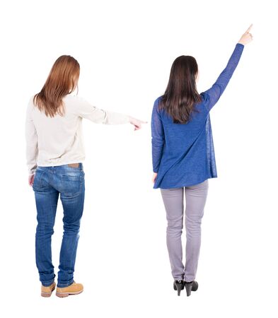 Back view of two pointing young girl in sweater. Rear view people collection. backside view of person. beautiful woman friends showing gesture. Rear view. Isolated over white background.の写真素材