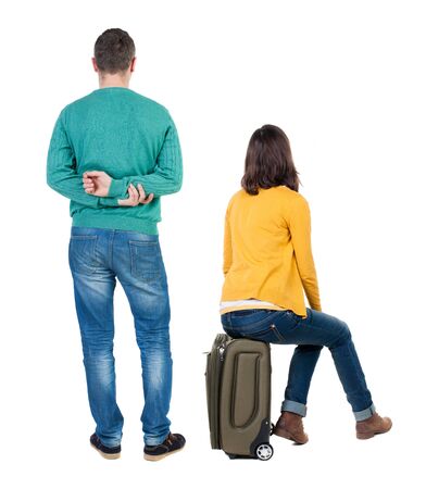 young couple in sweater traveling with suitcas. Back view. Rear view people collection. backside view of person. Isolated over white background.の写真素材