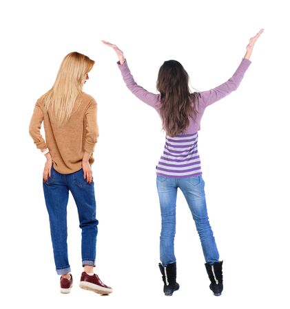 Back view of two woman in sweater. beautiful friendly girl and guy together. Rear view people collection. backside view of person. Isolated over white background.の写真素材