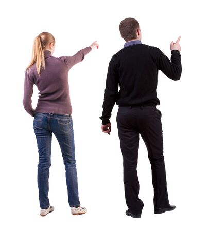 Back view of couple couple in sweater pointing. beautiful friendly girl and guy together. Rear view people collection. backside view of person. Isolated over white background.の写真素材
