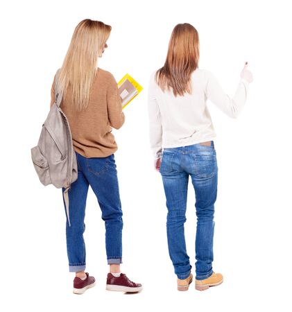 Back view of two woman in sweater. beautiful friendly girl and guy together. Rear view people collection. backside view of person. Isolated over white background.の写真素材