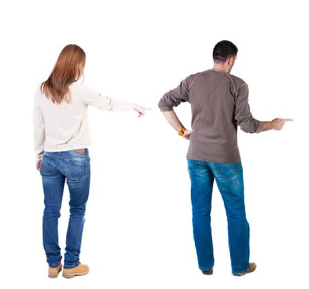 Back view of couple couple in sweater pointing. beautiful friendly girl and guy together. Rear view people collection. backside view of person. Isolated over white background.の写真素材