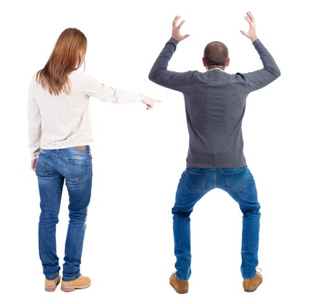 Back view of couple couple in sweater pointing. beautiful friendly girl and guy together. Rear view people collection. backside view of person. Isolated over white background.の写真素材