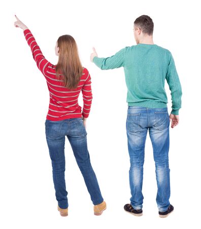 Back view of couple couple in sweater pointing. beautiful friendly girl and guy together. Rear view people collection. backside view of person. Isolated over white background.の写真素材