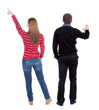 Back view of couple couple in sweater pointing. beautiful friendly girl and guy together. Rear view people collection. backside view of person. Isolated over white background.の写真素材