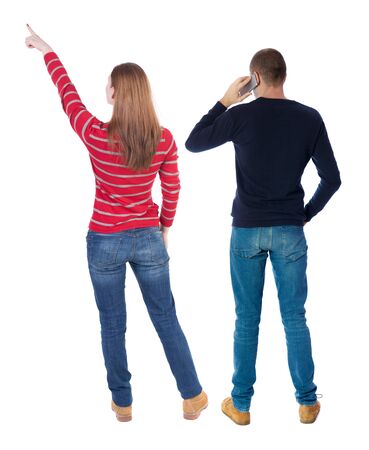 Back view of couple in sweater with mobile phone. beautiful friendly girl and guy together. Rear view people collection. backside view of person. Isolated over white background.の写真素材