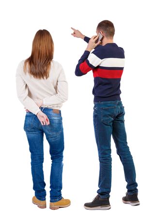Back view of couple in sweater with mobile phone. beautiful friendly girl and guy together. Rear view people collection. backside view of person. Isolated over white background.の写真素材