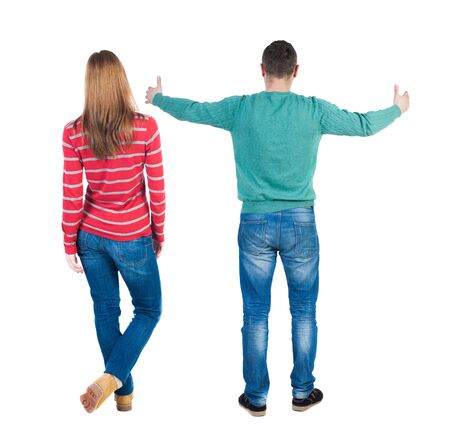 Back view of couple couple in sweater showing thumbs up. beautiful friendly girl and guy together. Rear view people collection. backside view of person. Isolated over white background.の写真素材