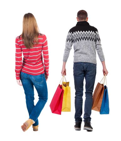 back view of couple with shopping bags. backside view of person. Rear view people collection. Isolated over white background.の写真素材