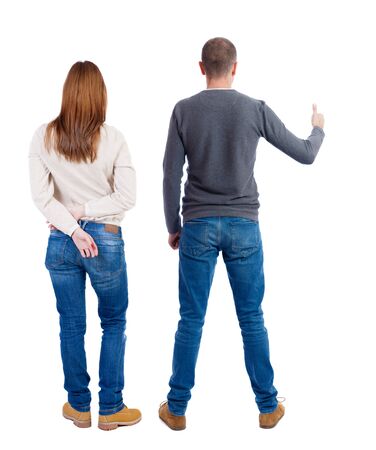 Back view of couple couple in sweater showing thumbs up. beautiful friendly girl and guy together. Rear view people collection. backside view of person. Isolated over white background.の写真素材